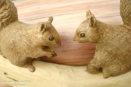 Two squirrels on branch wood carving up