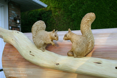 Two squirrels on branch wood carving
